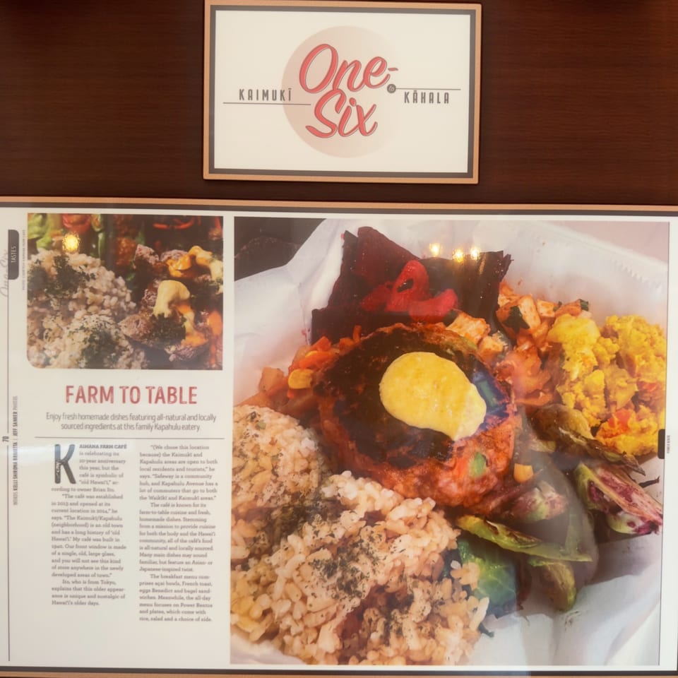 A Kaimana Farm Cafe Power Bento with brown rice, a burger patty, roasted vegetables, and scrambled eggs.