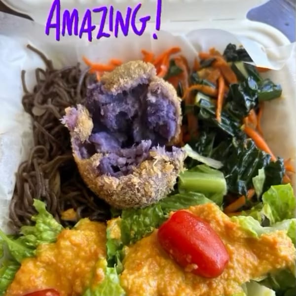 A Kaimana Farm Cafe healthy bowl with soba noodles, purple sweet potato croquette, greens, and dressing.
