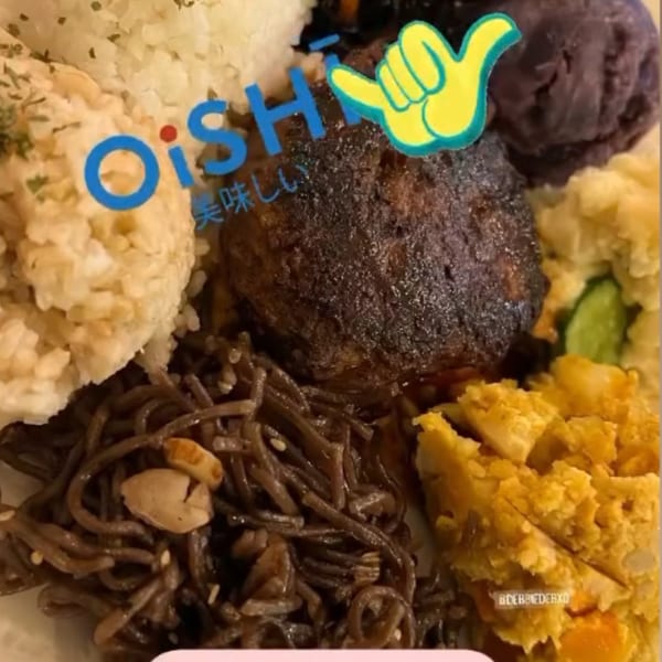 A Kaimana Farm Cafe healthy plate with rice, hamburger steak, noodles, and various side dishes.