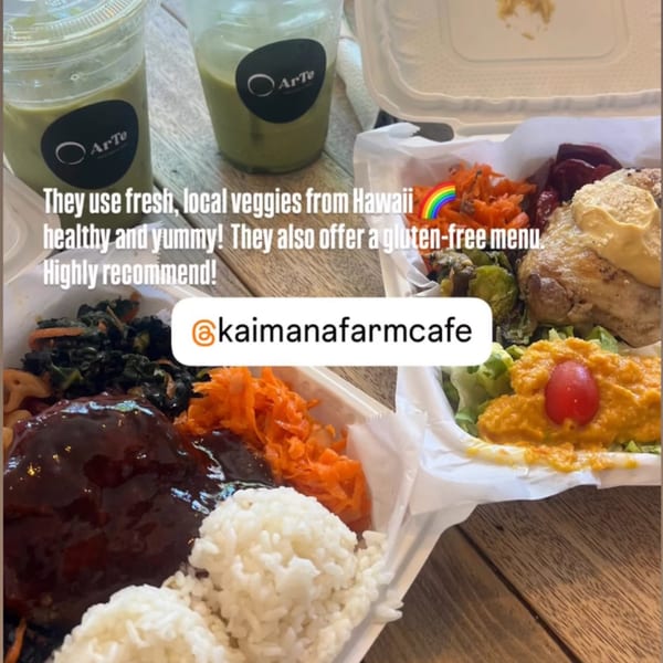Two healthy Kaimana Farm Cafe meals in takeout containers with green drinks on a wooden table.