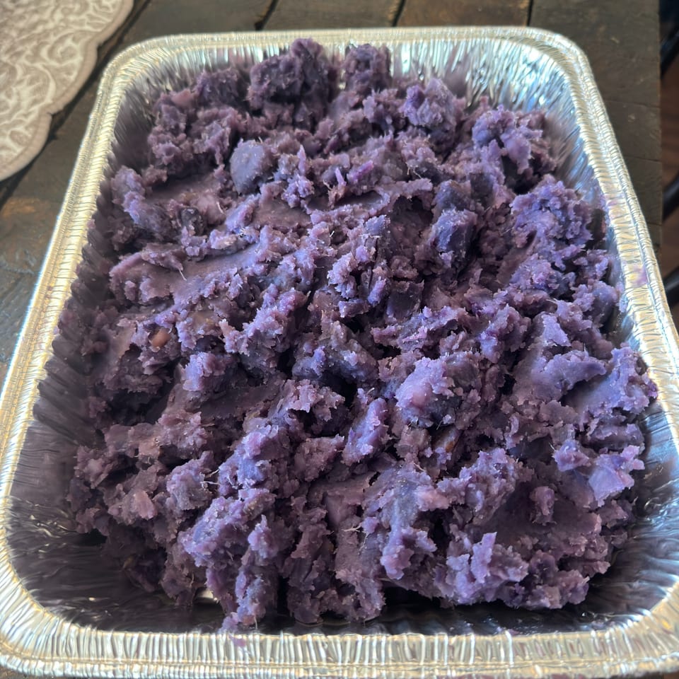 Purple mashed taro in a silver foil pan, a healthy side dish from Kaimana Farm Cafe.