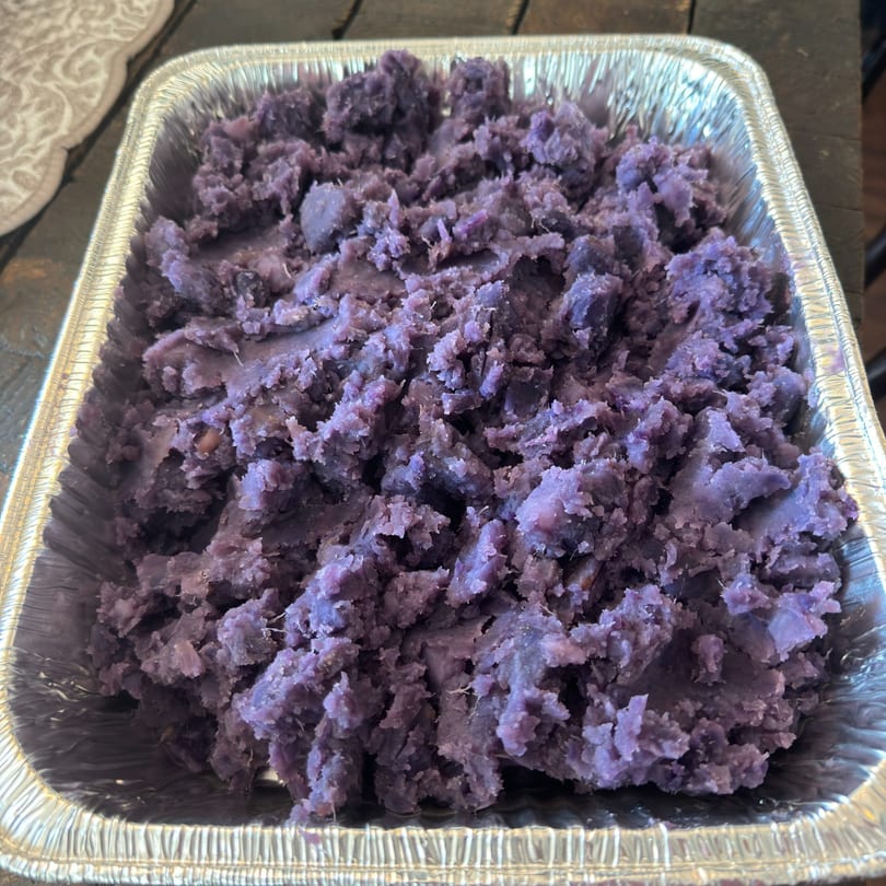 Purple mashed taro in a silver foil pan, a healthy side dish from Kaimana Farm Cafe.