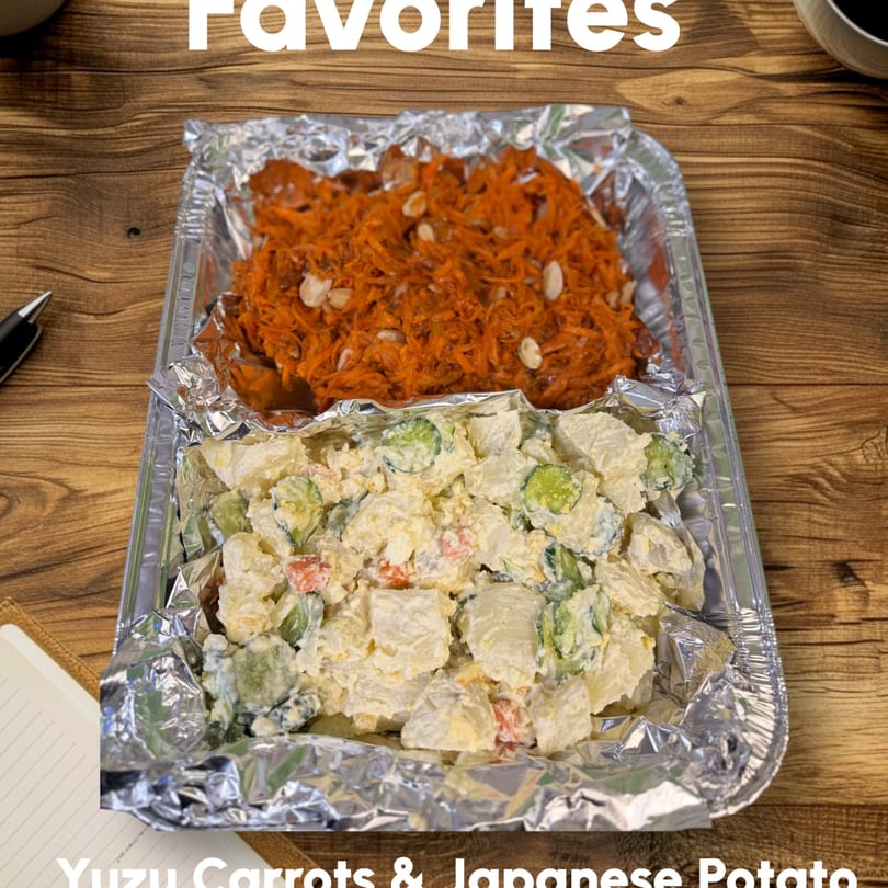 Two foil containers of Kaimana Farm Cafe's Yuzu Carrots and Japanese Potato Salad on a wooden table.